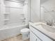 Clean bathroom featuring a tub and shower combo with a vanity and a stone countertop sink at 87 Addison Pond Ct, Zebulon, NC 27597