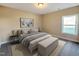 Cozy bedroom with neutral tones, a comfortable bed, and a sunlit window, enhancing its appeal at 87 Addison Pond Ct, Zebulon, NC 27597