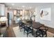 Dining area with modern furniture features open access to kitchen and a decorative vase with floral arrangement at 87 Addison Pond Ct, Zebulon, NC 27597