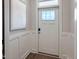 Stylish entryway with a white door with glass panels and a decorative wall hanging at 87 Addison Pond Ct, Zebulon, NC 27597