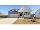 Charming two-story home with a gray exterior, white trim, and a front porch at 87 Addison Pond Ct, Zebulon, NC 27597