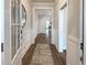 Hallway featuring an area rug and views into several rooms at 87 Addison Pond Ct, Zebulon, NC 27597