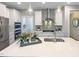 Well-appointed kitchen features a stainless steel range hood, gray backsplash, and a spacious quartz countertop island at 87 Addison Pond Ct, Zebulon, NC 27597