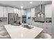 Stylish kitchen includes a central island with seating and stainless steel appliances with modern light fixtures at 87 Addison Pond Ct, Zebulon, NC 27597