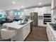 Bright kitchen boasts white cabinets, stainless steel appliances, and a large island with counter seating at 87 Addison Pond Ct, Zebulon, NC 27597