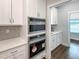 Modern kitchen includes built-in stainless steel microwave and oven appliances and white cabinets and countertops at 87 Addison Pond Ct, Zebulon, NC 27597