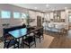 Bright open-concept kitchen and dining area feature modern lighting, stainless appliances, and a spacious island at 87 Addison Pond Ct, Zebulon, NC 27597