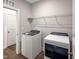 Bright laundry room with modern washer and dryer, complemented by a wire rack for storage at 87 Addison Pond Ct, Zebulon, NC 27597