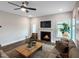 Cozy living room showcases a fireplace, a ceiling fan, and a comfortable seating arrangement at 87 Addison Pond Ct, Zebulon, NC 27597