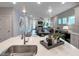 Open-concept living and dining area showcases modern lighting and seamless flow from kitchen to living spaces at 87 Addison Pond Ct, Zebulon, NC 27597