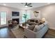 Comfortable living room with a fireplace, neutral-toned sofas, and a ceiling fan at 87 Addison Pond Ct, Zebulon, NC 27597