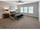 Spacious main bedroom with a king-size bed, ceiling fan, and natural light from three windows at 87 Addison Pond Ct, Zebulon, NC 27597