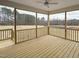 Screened-in porch offers a serene outdoor living space with views of the expansive backyard at 87 Addison Pond Ct, Zebulon, NC 27597