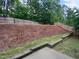 A backyard featuring a wooded area and a wooden fence at 8844 Forester Ln, Apex, NC 27539
