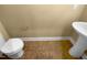 This half bathroom features ceramic floors and a modern pedestal sink at 8844 Forester Ln, Apex, NC 27539