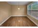 Bright dining room featuring hardwood floors, large windows, and neutral walls to match any style at 8844 Forester Ln, Apex, NC 27539