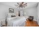 Comfortable bedroom featuring a ceiling fan, hardwood floors, and plenty of natural light at 903 S 2Nd St, Smithfield, NC 27577
