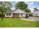 Charming single story home with brick accents, manicured landscaping, and covered parking at 903 S 2Nd St, Smithfield, NC 27577
