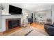 Bright living room featuring fireplace, hardwood floors, and dining area access at 903 S 2Nd St, Smithfield, NC 27577