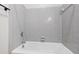 Bathroom featuring a bathtub with gray tiles and a chrome showerhead at 1000 Brighthurst Dr # 104, Raleigh, NC 27605