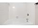 Bathroom featuring a bathtub with white tiles and chrome showerhead at 1000 Brighthurst Dr # 104, Raleigh, NC 27605