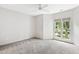 Bright bedroom featuring carpet and a large window overlooking the leafy outdoors at 1000 Brighthurst Dr # 104, Raleigh, NC 27605