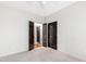 Bedroom featuring neutral walls, carpet, and access to other rooms; ideal for comfort at 1000 Brighthurst Dr # 104, Raleigh, NC 27605