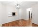 Bright dining room with wood floors, modern chandelier and convenient kitchen pass-through at 1000 Brighthurst Dr # 104, Raleigh, NC 27605