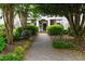 Inviting exterior entrance with a brick walkway and lush landscaping at 1000 Brighthurst Dr # 104, Raleigh, NC 27605