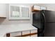 Kitchen showcasing white countertops and black refrigerator with a view to the backyard at 1000 Brighthurst Dr # 104, Raleigh, NC 27605