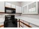 Bright kitchen with black appliances, white countertops, and white cabinets at 1000 Brighthurst Dr # 104, Raleigh, NC 27605