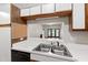 Functional kitchen with stainless steel sink and a view of the living room at 1000 Brighthurst Dr # 104, Raleigh, NC 27605