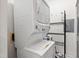 Stackable washer and dryer create a functional laundry space with extra shelving at 1000 Brighthurst Dr # 104, Raleigh, NC 27605
