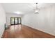 Spacious living room with hardwood floors, fireplace, and sliding glass doors to the outside at 1000 Brighthurst Dr # 104, Raleigh, NC 27605