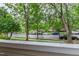 Neighborhood view from the porch lined with trees at 1000 Brighthurst Dr # 104, Raleigh, NC 27605