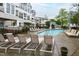 Community pool with lounge chairs to enjoy the sun and shade at 1000 Brighthurst Dr # 104, Raleigh, NC 27605