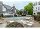 Community pool surrounded by lounge chairs and tables for residents' enjoyment at 1000 Brighthurst Dr # 104, Raleigh, NC 27605