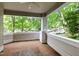 Charming brick porch offering serene neighborhood views with a ceiling fan at 1000 Brighthurst Dr # 104, Raleigh, NC 27605