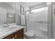 Bright bathroom with a walk-in shower, a framed mirror, and clean features at 1002 Addington Lake Ln, Knightdale, NC 27545