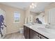 Bright bathroom with a double sink vanity, tile floors, and large window with a shower at 1002 Addington Lake Ln, Knightdale, NC 27545