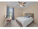 Bedroom with a large window with curtains, wooden desk and chair, and a ceiling fan at 1002 Addington Lake Ln, Knightdale, NC 27545