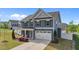 Charming two-story home with blue siding and manicured lawn and landscaping at 1002 Addington Lake Ln, Knightdale, NC 27545