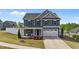 Charming two-story home with blue siding, white trim, and a well-manicured front yard at 1002 Addington Lake Ln, Knightdale, NC 27545
