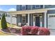 Inviting front porch with chairs, hanging planters, and colorful landscaping at 1002 Addington Lake Ln, Knightdale, NC 27545