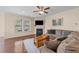 Cozy living room with a fireplace, large windows, and comfortable seating at 1002 Addington Lake Ln, Knightdale, NC 27545