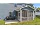 Rear exterior showcasing the screened porch and the well-maintained backyard at 1002 Addington Lake Ln, Knightdale, NC 27545