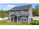 Rear exterior of home showing the screened-in porch and spacious backyard at 1002 Addington Lake Ln, Knightdale, NC 27545