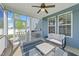 Relaxing screened porch featuring a ceiling fan, string lights, and outdoor furniture at 1002 Addington Lake Ln, Knightdale, NC 27545