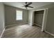 Neutral bedroom featuring wood flooring, a window, and a closet for storage at 1064 Abbott Rd, Henderson, NC 27537