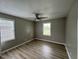 Bedroom with laminate wood flooring, gray walls, and natural light from two windows at 1064 Abbott Rd, Henderson, NC 27537